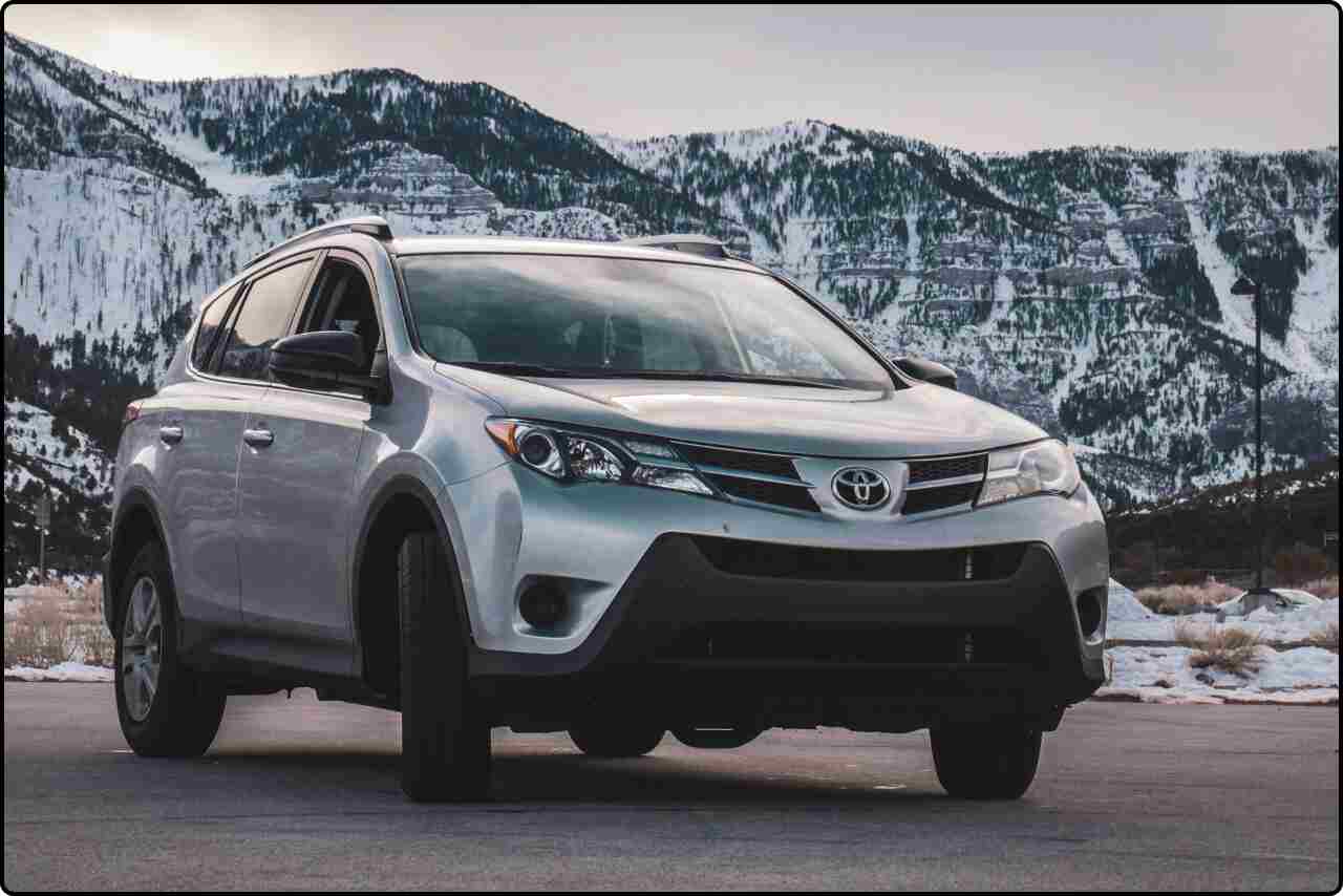 Gray Toyota RAV4 on a scenic mountain road.